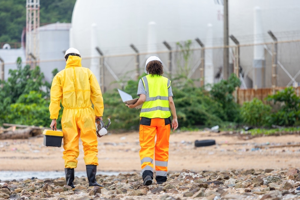 Environmental Workers Inspecting Industrial Site